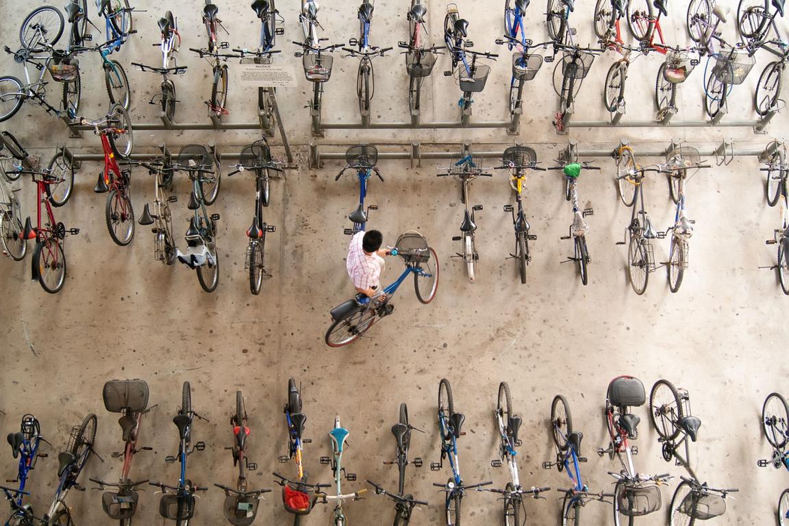 man putting bicycle up aerial view